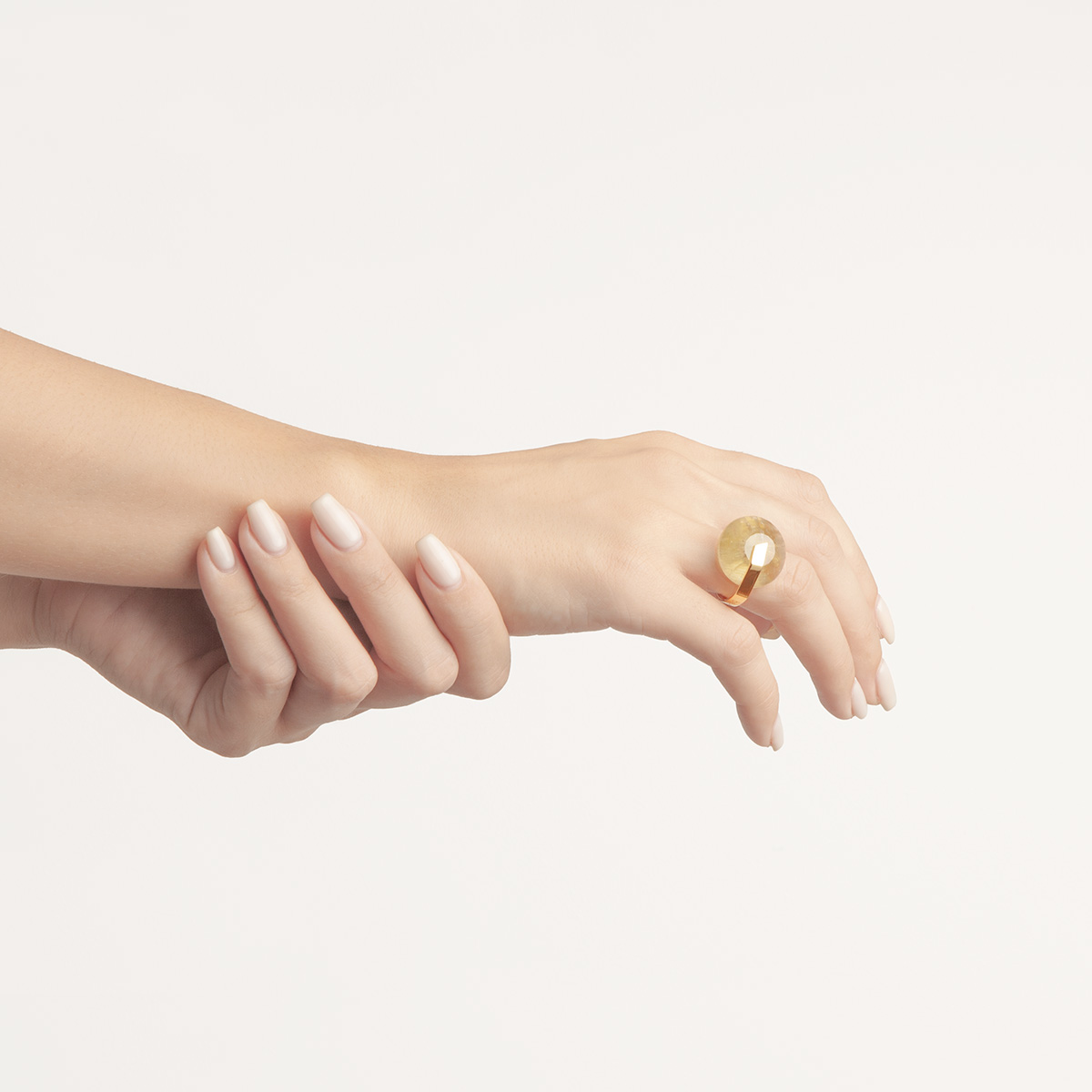 Handmade Gau ring in 18k gold plated 925 silver and rutilated quartz on hands designed by Belen Bajo